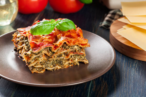 istock Piece of tasty hot lasagna with spinach on a plate 934486254
