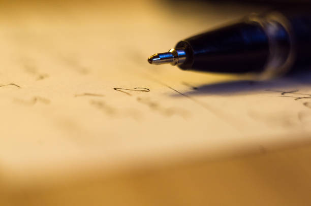istock ball point pen and a sheet of paper 934488718