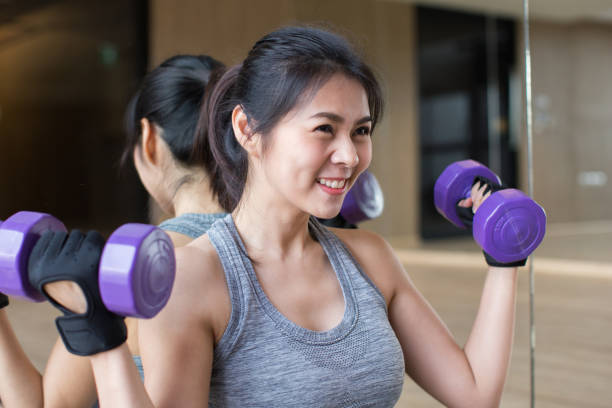 istock girl on dumbbells 934491450
