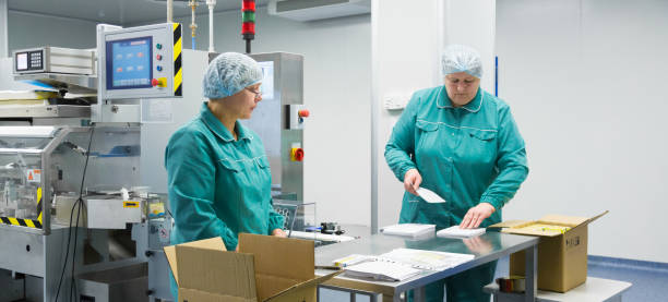 istock Pharmaceutical factory workers in sterile environment 934491772