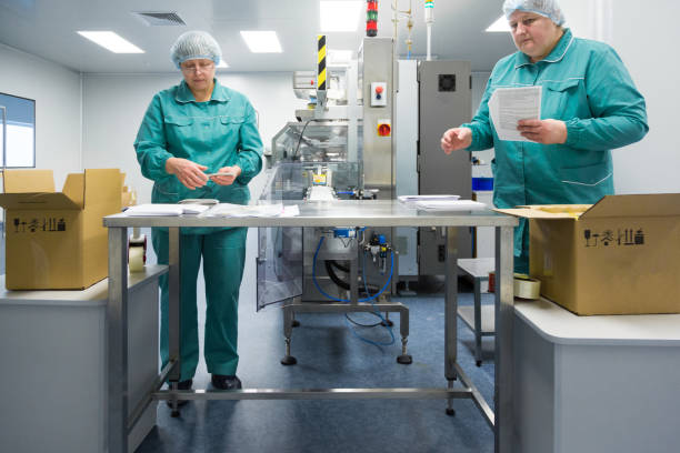 istock Pharmaceutical factory workers in sterile environment 934491774
