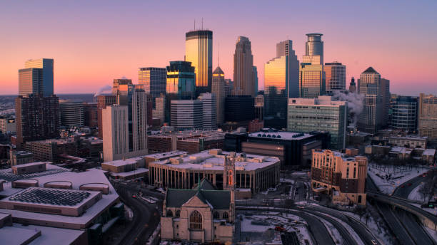 Minneapolis Skyline at Dusk Aerial Shot of Downtown Minneapolis, Minnesota at Sunset - March 2018 minneapolis stock pictures, royalty-free photos & images