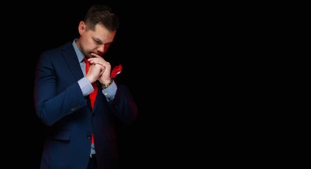 istock Portrait of confident handsome businessman thinking on black background 934492642