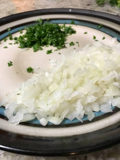 istock Plate of chopped onions and parsley 934492928