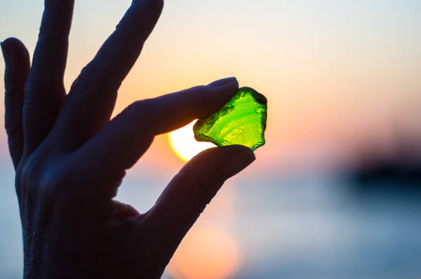 istock sea smoothed green glass in hand 934499438