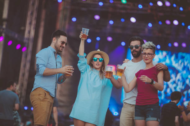 istock Hipster people dancing at festival and drinking beer 934499460