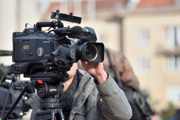 TV camera man filming a political event Vilnius, Lithuania - April 15, 2018: TV camera man filming a political event in Vilnius on April 15, 2018. Vilnius is the capital of Lithuania and its largest city television show stock pictures, royalty-free photos & images