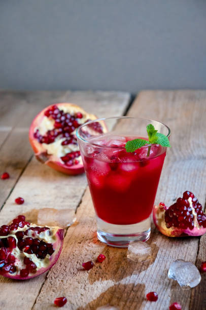 istock Pomegranate Cocktail with Ice Mint and Fruit on Wooden Table. Refreshing Summer Drink Soft or Alcoholic 934506128