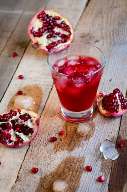 istock Pomegranate Cocktail with Ice and Fruit on Wooden Table. Refreshing Summer Drink Soft or Alcoholic 934506134