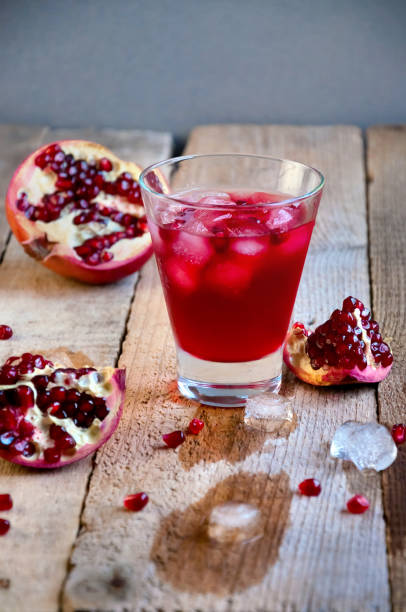 istock Pomegranate Cocktail with Ice and Fruit on Wooden Table. Refreshing Summer Drink Soft or Alcoholic 934506138