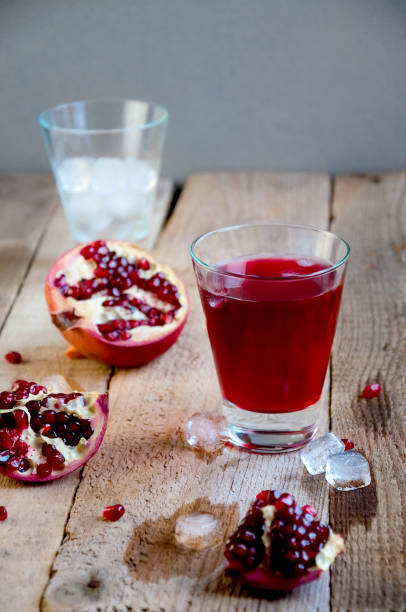 istock Pomegranate Juice with Ice and Fruit on Wooden Table. Refreshing Summer Drink 934506144