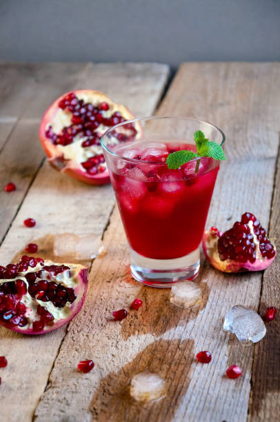 istock Pomegranate Cocktail with Ice Mint and Fruit on Wooden Table. Refreshing Summer Drink Soft or Alcoholic 934506156