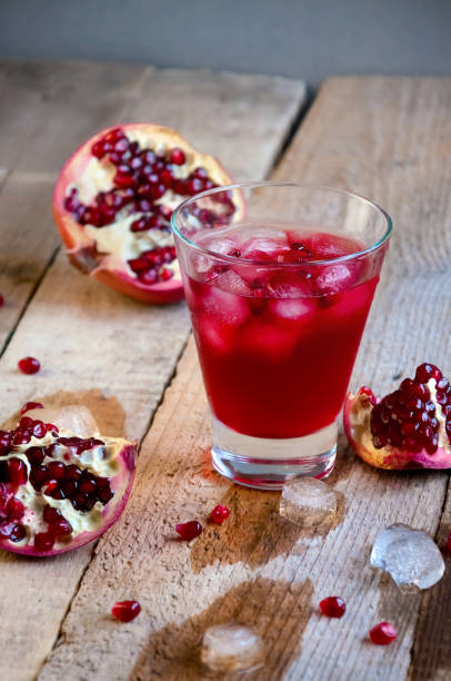 istock Pomegranate Cocktail with Ice and Fruit on Wooden Table. Refreshing Summer Drink Soft or Alcoholic 934506160