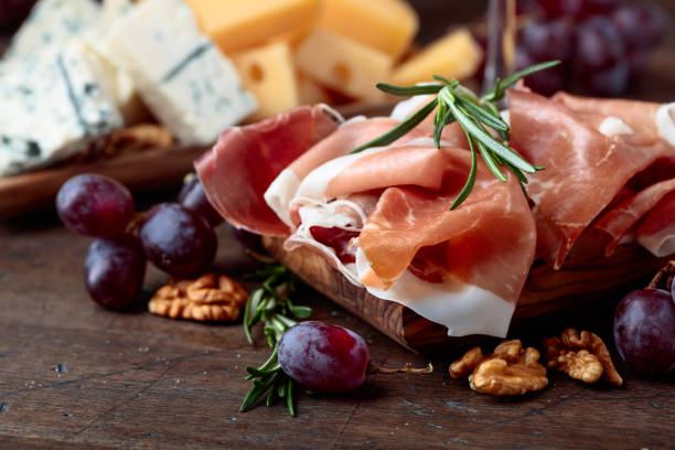 istock Prosciutto with various cheeses , grapes and  walnuts . 934506490