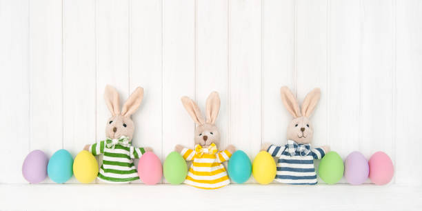 istock Easter decoration eggs funny bunnies wooden background 934506840