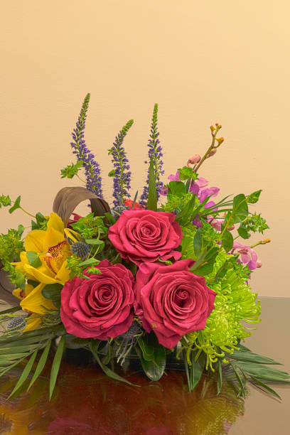 Pink roses, yellow cymbidium , green mums