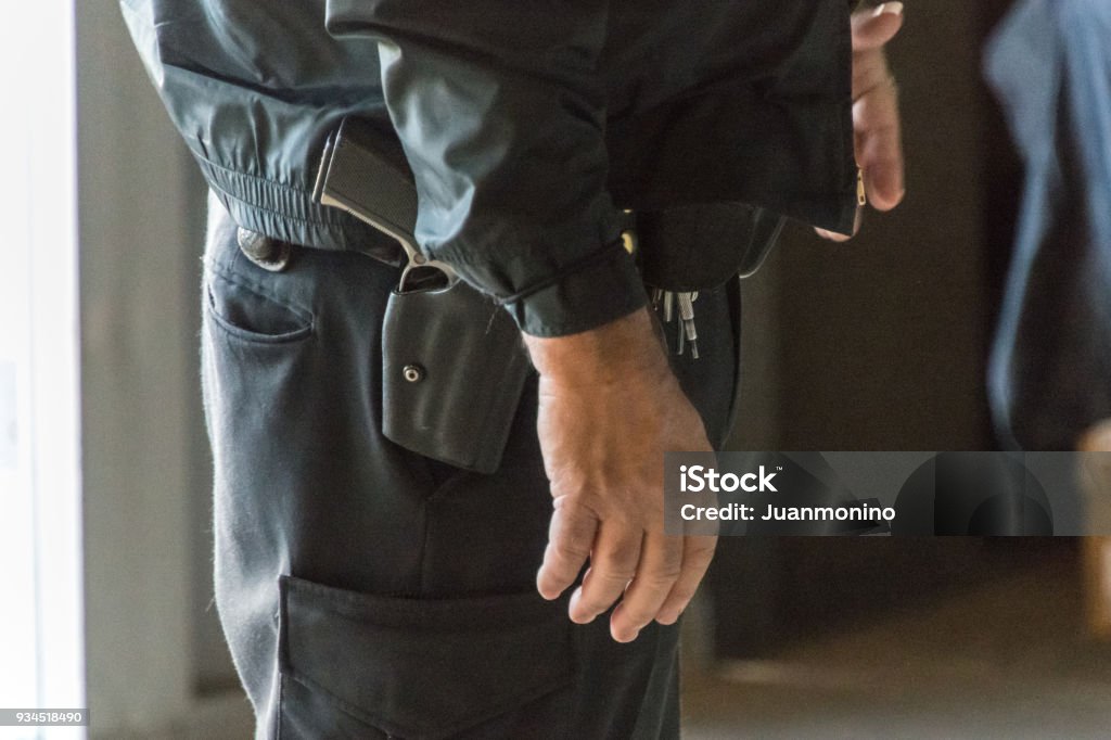 Armed Teacher Armed teacher standing at the school entrance School Building Stock Photo