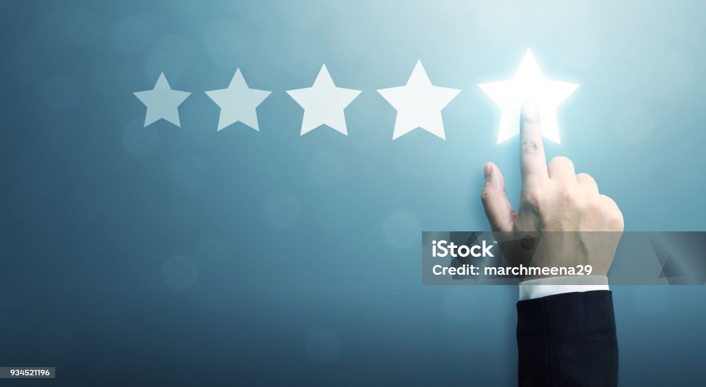 Hand of businessman touching five star symbol to increase rating of company concept, Copy space background for your title Quality Stock Photo