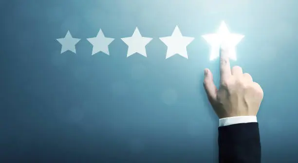 Photo of Hand of businessman touching five star symbol to increase rating of company concept, Copy space background for your title