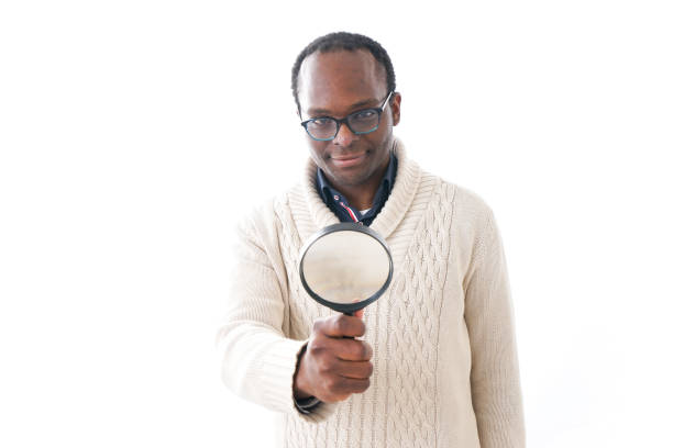 istock Man looking at something through a magnifying glass 934525786