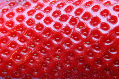 Strawberry skin texture close-up. Food background.