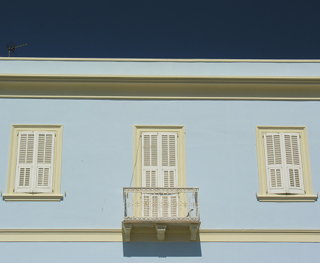 Typical southern European, Mediterranean balcony, on top floor of house, with deep blue cloudless sky above - photographed in Carloforte, Isola di San Pietro, Sardinia, Italy