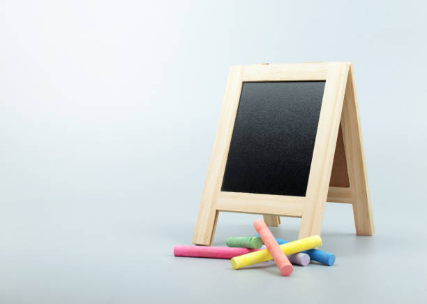 istock chalkboard, blackboard stand with chalk on clean background. 934556796