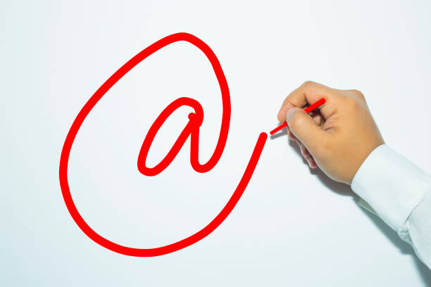 istock Man's hand writing with pencil the word: E-mail sign. 934561608