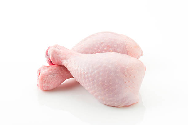 Raw skin on chicken legs cross each other Two Fresh Chicken Legs on White. See Related Photos on my Portfoliohttp://i1215.photobucket.com/albums/cc503/carlosgawronski/FoodonWhite.jpg chicken leg stock pictures, royalty-free photos & images
