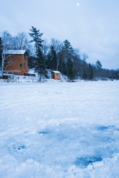 istock Frozen lake with ice fishing holes 934566448