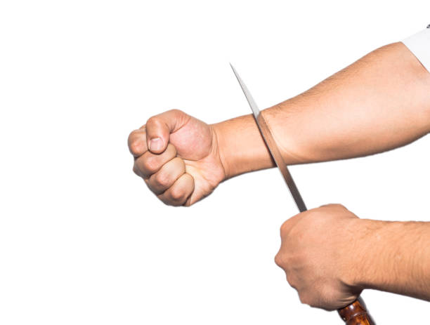 istock Man want to commit suicide by cutting his veins with knife on white background ISOLATED. 934566636