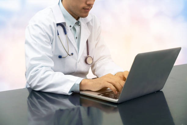 istock Doctor working on desk with laptop 934566714