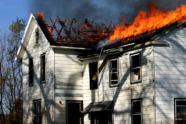 istock Second story fire in a white house with roof up in flames 93456922
