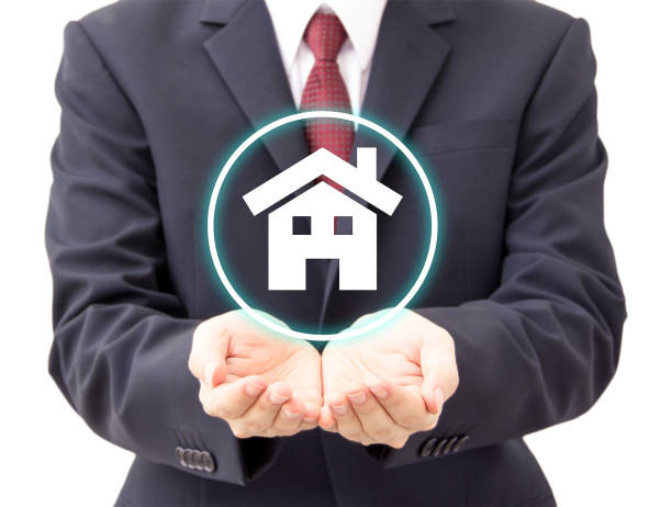 istock businessman holding house icon 934582356
