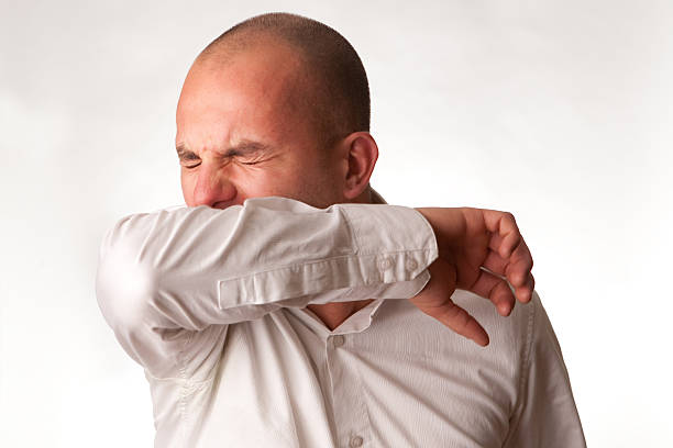 istock Man in mid cough demonstrating proper hygienic procedure 93458614