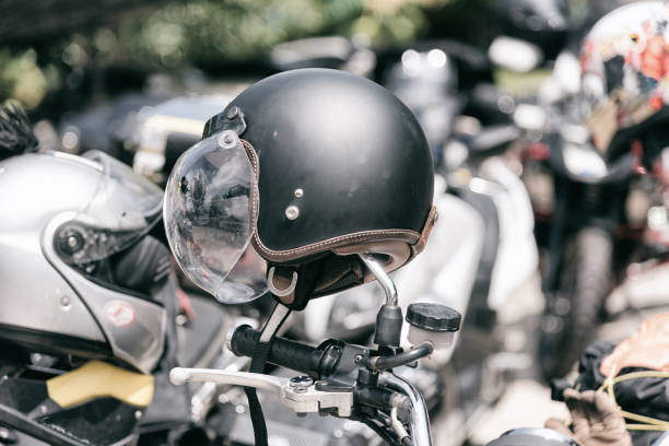 istock Vintage motorcycle helmet hanged on motorcycle in selective focus. 934587842