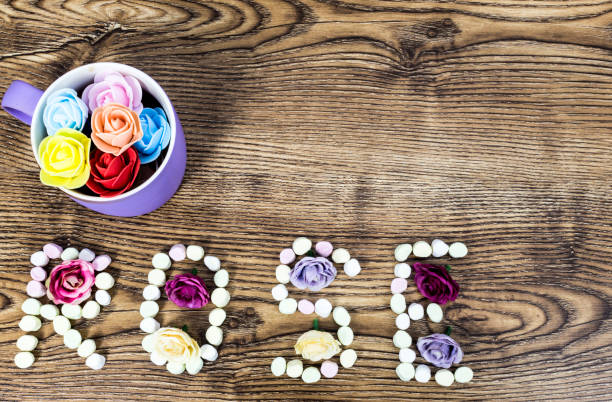 istock cup of button roses with the text rose formed with marshmallows on wooden table. 934590664