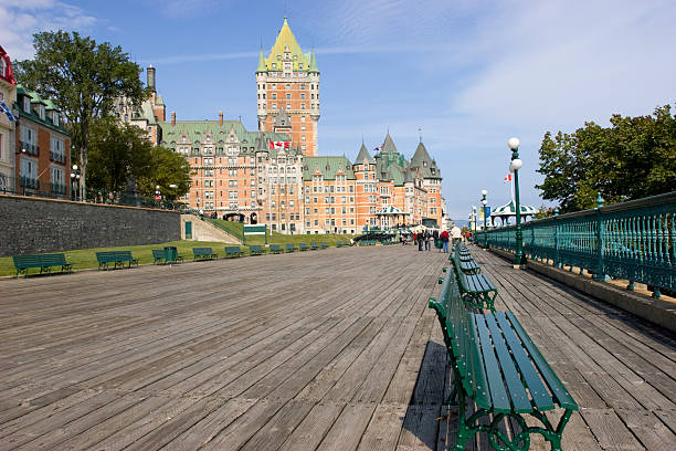 Old Quebec stone row of houses with Québec Château Frontenac on top, in the backgound . Canada. Black and white view.