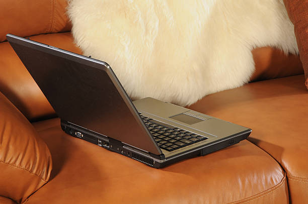 laptop on a sofa stock photo