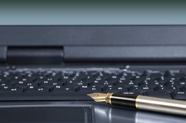 Fragment of laptop with a pen stock photo