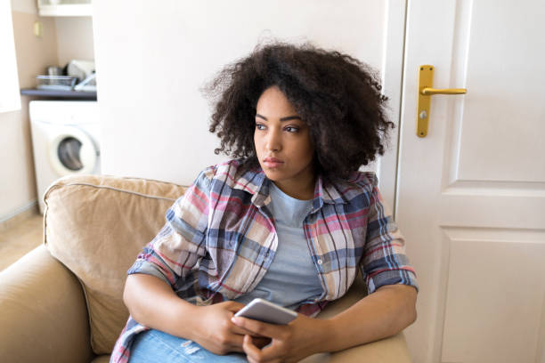 istock Smiling african woman social networking at home 934617154