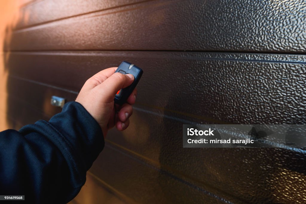 Garage door PVC Hand use remote controller for closing and opening garage door Door Stock Photo