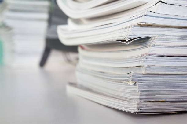 istock stacked magazine books on white table 934621526