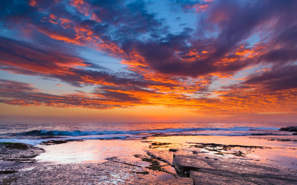 istock Vibrant Sunrise Seascape from Rock Platform 934624420