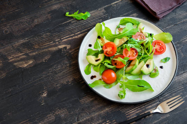 istock Avocado and tomatoes salad with arugula 934626230