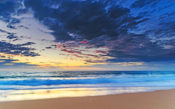 istock Seascape - Sunrise at the Beach with Clouds 934631260