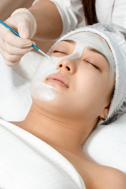 istock cosmetologist puts a mask on the face 934634024