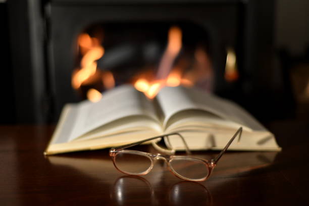 istock Old Reading Glasses On Old Book And Fireplace 934634378