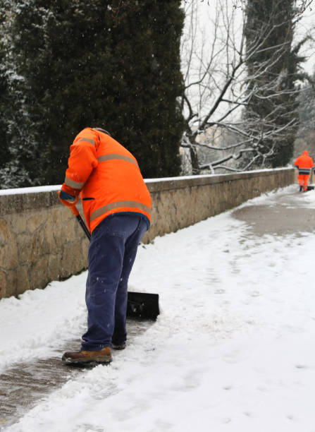 istock garbage man shovels the snow from the pavement after heavy snowfall 934634542