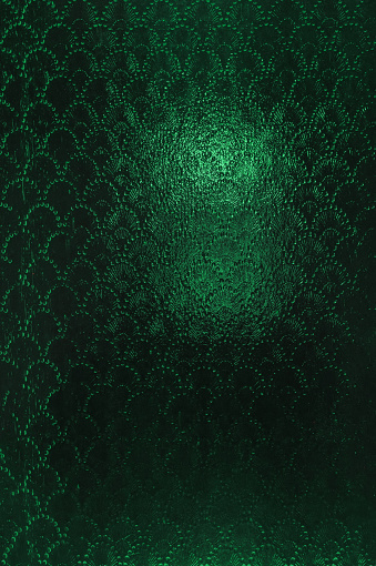 Vintage clouded glass with a slightly blurred abstract pattern. Vintage green Textured dark background.